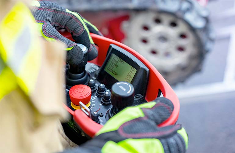 firefighter holding the Fumo control joystick