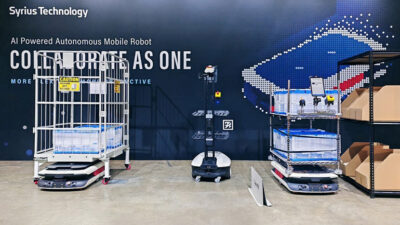 three Syrius technology mobile robots lined up at a tradeshow.