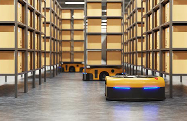 A yellow and black Liftians AGV navigating the floor of a warehouse with two more in the background carrying racks. EdgeNectar promises to improve its performance with 5G.