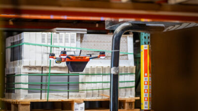 Corvus drone flying in a warehouse.