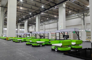 A warehouse with several bright green autonomous mobile robots from Libiao Robotics.
