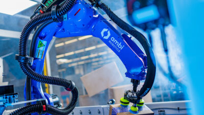 An Ambi Robotics' robotic arm picking up a box.