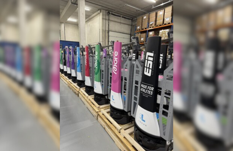 An image of a row of Locus Origin robots with various different branding for The Quality Group brands.