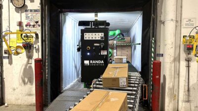 A green Pickle Robot operating in a container at Randa.