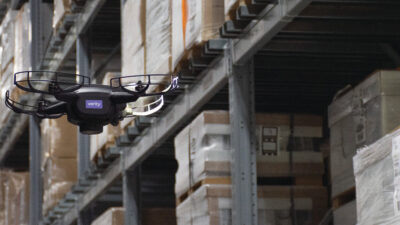 A Verity drone flying through a warehouse.