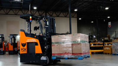 A Fox Robotics automated forklift lifting a pallet.