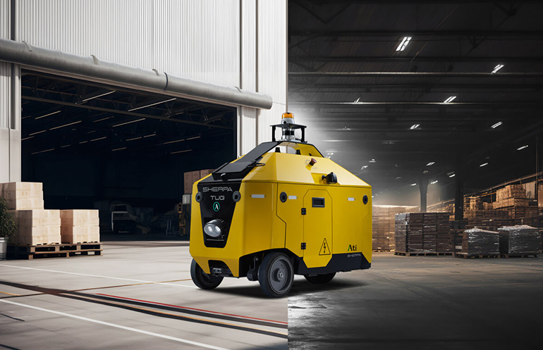 The Sherpa Tug from Ati Motors is shown working both outdoors and indoors.