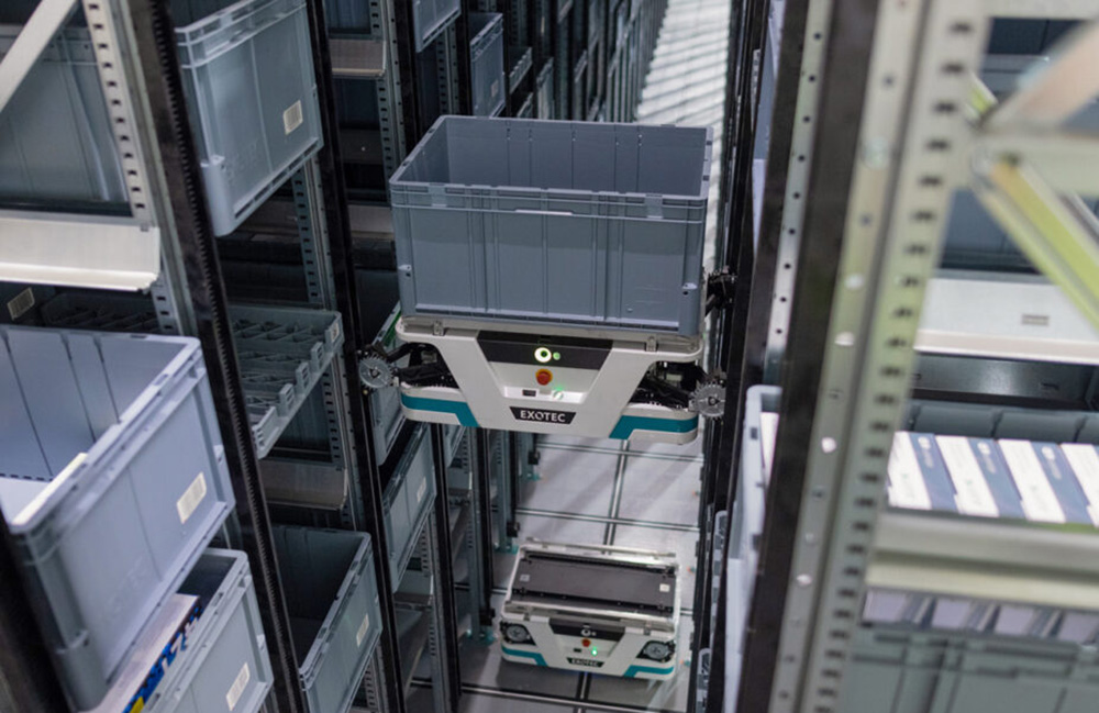 An image of Exotec's robot moving up shelving in an ASRS like the one at Oxford Industries.