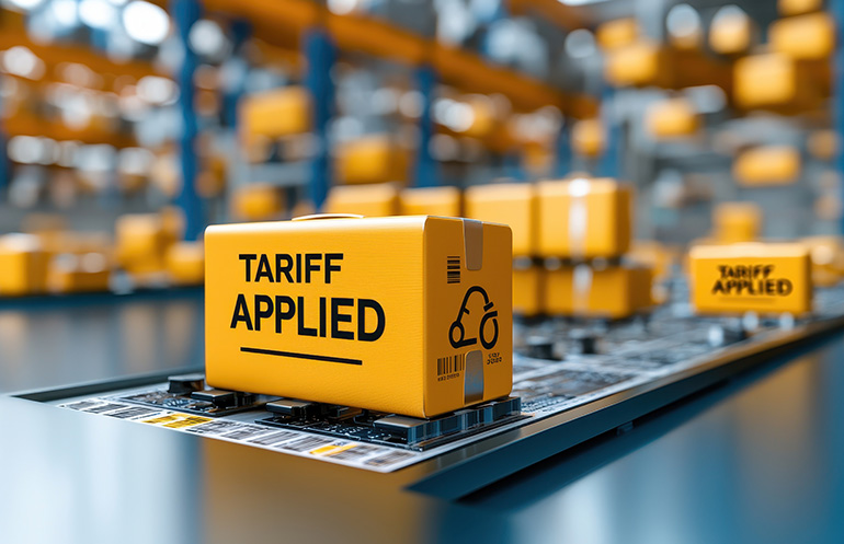Boxes marked "Tariff Applied" on a conveyor belt. Tariffs pose challenges to supply chains, but software and automation can help supply chains adapt, says Infios.