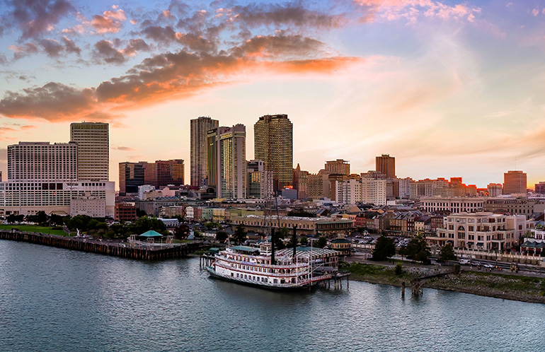 New Orleans River Paddle boat cloudy sky sunset. WERC 2025 will be in the city in June.