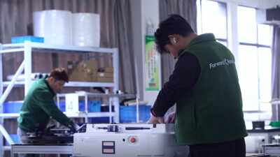 People working to build ForwardX robots at its new facility.
