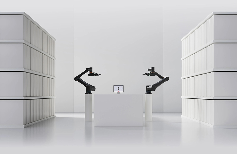 Two Standard Bot robot arms in a white room.