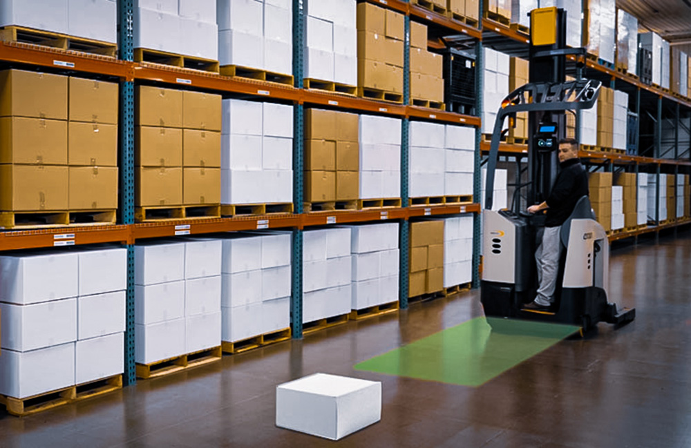 A forklift approaching a box in a warehouse with a green box showing the ProximityAssist view.