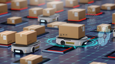 An stock image of AMRs on a warehouse floor moving boxes.