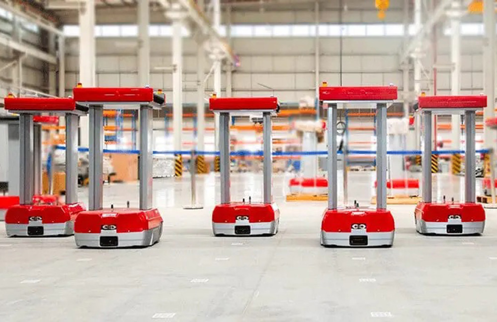 Five red Zippy sorting robots from Addverb in a warehouse. Addverb is working with Infineon on BLE-based communications.