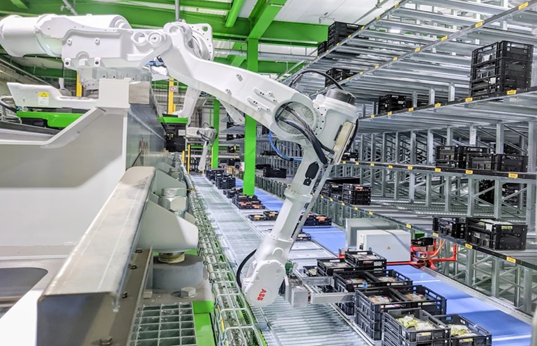 An IRB 6700 six-axis robot from ABB places crats into 'pigeon holes.'
