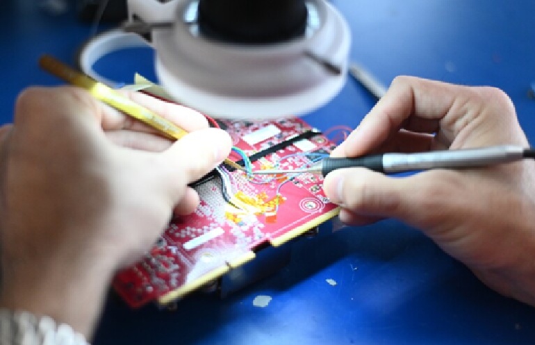 An Amazon Web Services engineer works on the AWS Trainium generative AI chip.