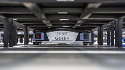 A Geekplus shelf-to-person robot picking up a shelf.