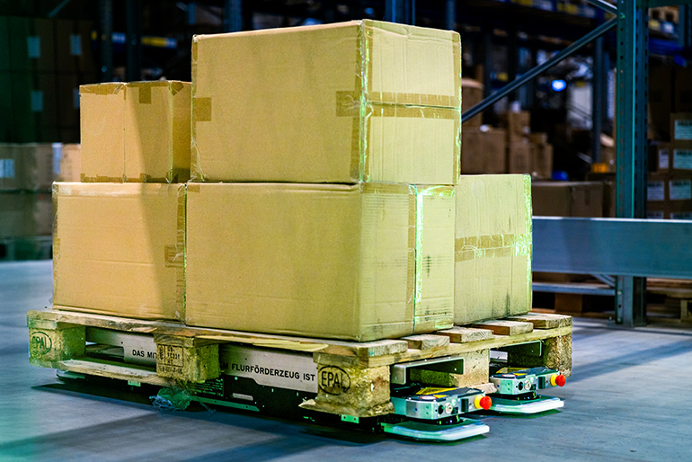 Filics units move a heavily loaded pallet through a warehouse.
