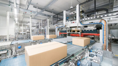 An image of boxes moving across a conveyor belt in a warehouse.