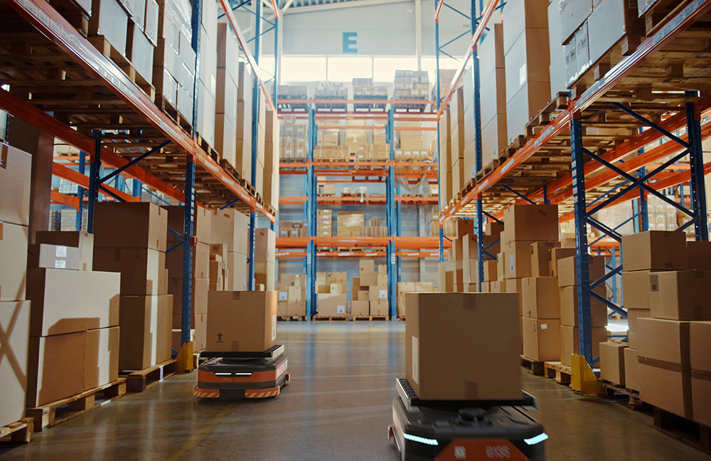 A stock image of autonomous mobile robots in a warehouse. Fire safety is an emerging area of concern as fleets grow.