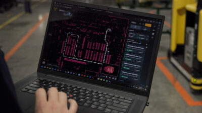A person holding a laptop showing the Hyster Atlas screen.
