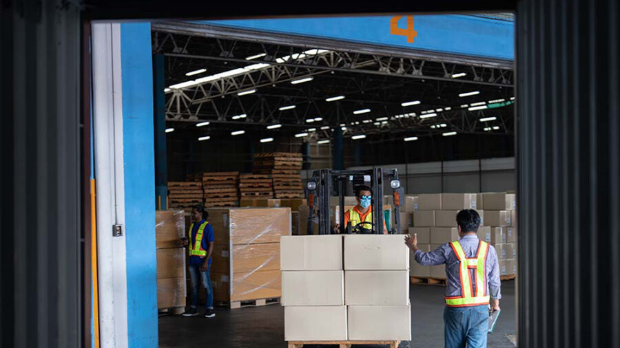 People moving a pallet of boxes through the Acceliot Smart Space Portal.