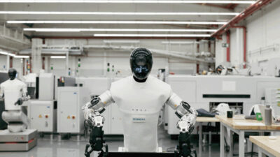 A robot from Humanoid picking up a tote.