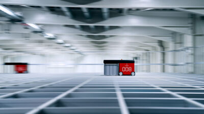 An AutoStore robot on top of the grid.